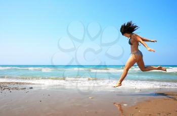 Royalty Free Photo of a Woman Running on a Beach