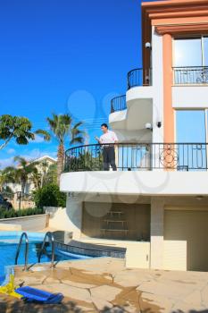 Royalty Free Photo of a Man on a Balcony