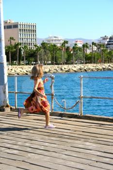 Royalty Free Photo of a Girl Running on a Pier