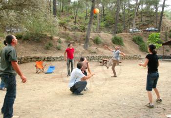 Royalty Free Photo of People Playing Ball in the Forest