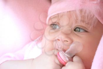 Royalty Free Photo of a Baby Holding a Pacifier