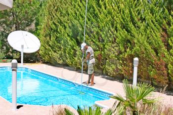Royalty Free Photo of a Man Cleaning a Pool