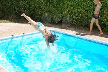 Royalty Free Photo of a Woman Jumping into a Swimming Pool