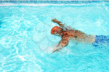 Royalty Free Photo of a Man Swimming in a Pool