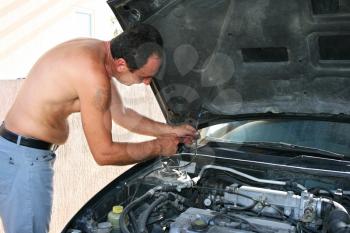 Royalty Free Photo of a Man Repairing a Car