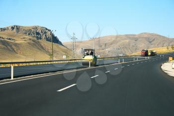 Royalty Free Photo of an Asphalt Paving Machine on the Road