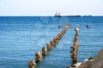 Royalty Free Photo of a Ship by an Old Pier