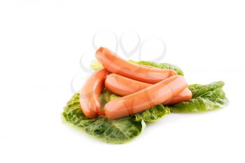 Sausages and lettuve leaves isolated on white background.