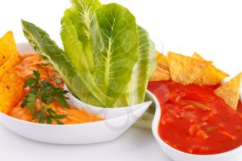 Nachos,  cheese and red sauce, vegetables isolated on white background.