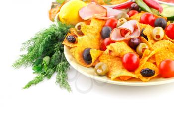 Nachos, olives, pork loin and vegetables isolated on white background.