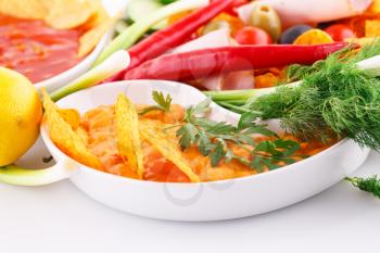 Nachos,  cheese and red sauce, vegetables image.