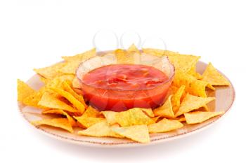 Nachos on plate and red sauce isolated on white background.