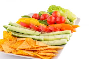 Nachos and vegetables isolated on white background.