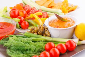 Vegetables, olives, nachos, red and cheese sause image.
