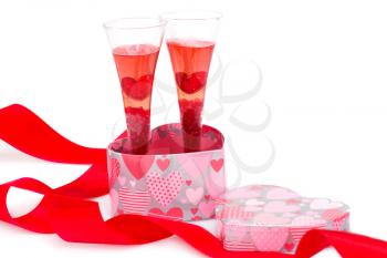 Red ribbon, two glasses and gift box isolated on white background.