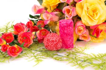 Colorful roses and candles isolated on white background.