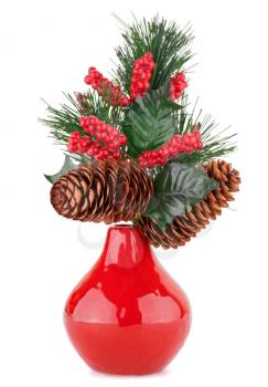 Christmas decoration in red vase isolated on white background.