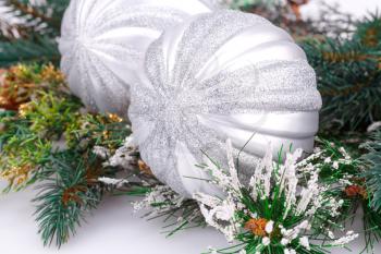 Christmas decoration with gray balls and fir tree branch.