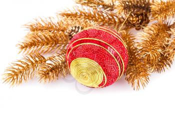 Christmas decoration with ball and golden fir tree branch isolated on white background.