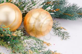 Christmas decoration with yellow balls and fir-tree branch.