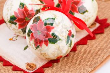 Christmas colorful balls with ribbons on canvas background.