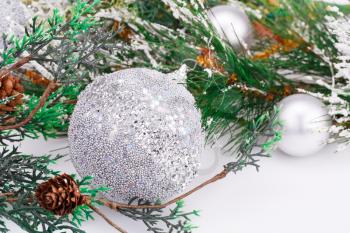 Christmas balls and fir tree on gray background.