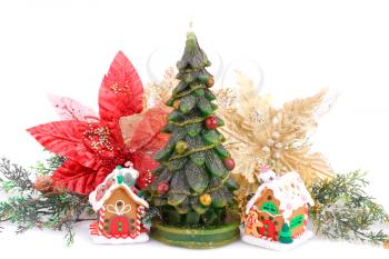 Fir tree candles, toy houses and holly berry flowers  isolated on white background.