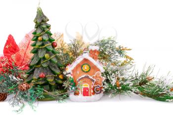 Fir tree candle, toy house and holly berry flowers on white background.