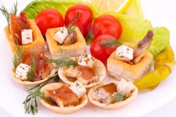 Smoked fish  and feta cheese in pastries and fresh vegetables.