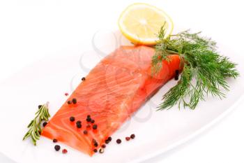 Salmon fillet with lemon, dill on plate isolated on white background.