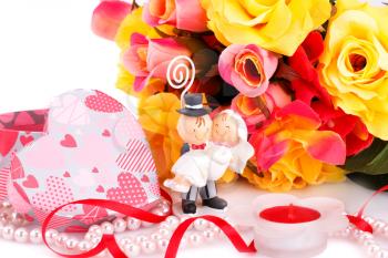 Colorful roses, bride and fiance, candle and gift box close up picture.