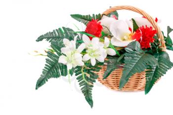 Colorful fabric flowers in wicker basket isolated on white background.