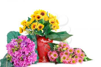 Yellow fabric flowers in vase and pink flowers isolated on white background.
