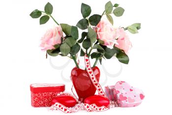 Red heart candles, roses in vase, necklace and gift boxes on white background.