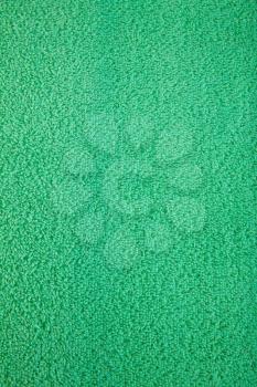 Green towel texture as a background, closeup picture.
