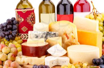 Various type of cheese,wines and grapes on wooden board closeup picture.