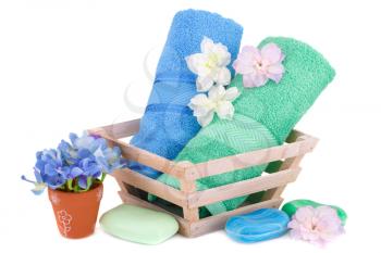 Spa set with towels, soaps and flowers isolated on white background.