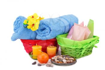 Spa set with towels, creams, lotions, candles, stones and flower isolated on white background.