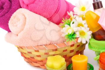 Spa set with towels, creams, lotions, candles and flowers on white background.