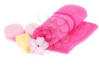Towel, soaps and flower isolated on white background.