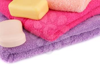 Colorful towels stack and soaps closeup picture.