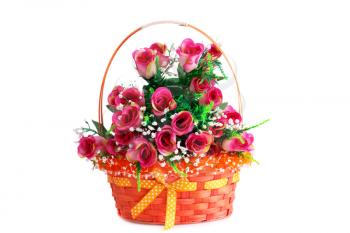 Pink fabric roses in wicker basket isolated on white background.