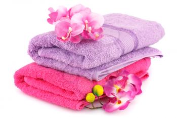 Colorful folded towels with flowers isolated on white background.