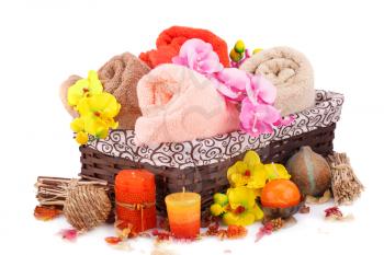 Spa set with towels, candles and flowers isolated on white background.
