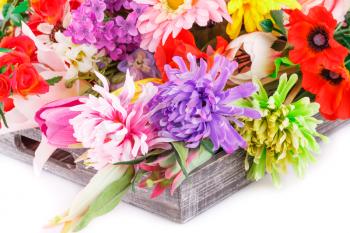 Colorful fabric flowers in wooden box.