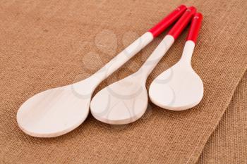 Wooden utensils on fabric background.