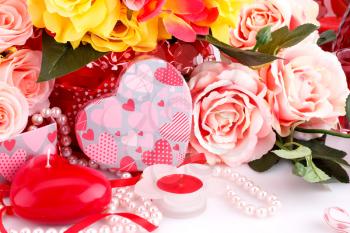 Colorful roses, candles, beads and gift box close up picture.