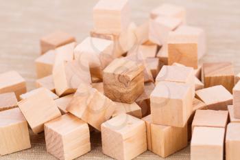 Wooden cubes on beige fabric background.