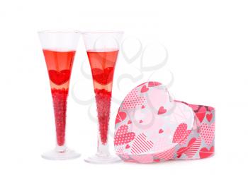 Two glasses with red candle and gift box isolated on white background.