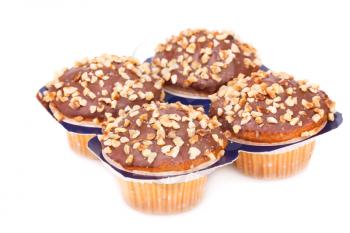 Four muffins with chocolate and nuts isolated on white background.